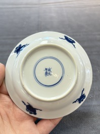 A pair of Chinese blue and white 'Elegant Beauty and Boy' cups and saucers, Chenghua mark, Kangxi