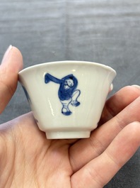 A pair of Chinese blue and white 'Elegant Beauty and Boy' cups and saucers, Chenghua mark, Kangxi