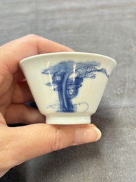 A pair of Chinese blue and white 'elegant beauty and boy' cups and saucers, Chenghua mark, Kangxi