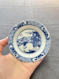 A pair of Chinese blue and white 'elegant beauty and boy' cups and saucers, Chenghua mark, Kangxi