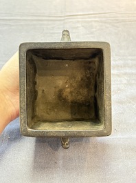 A Chinese archaistic bronze square censer with two handles, Xuande mark, Qing