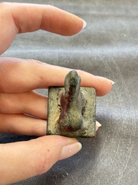 Five Chinese bronze seals and an Indonesian bronze figure group, 18/19th C.