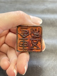 Five Chinese bronze seals and an Indonesian bronze figure group, 18/19th C.
