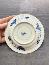 A set of six Chinese blue and white cups and saucers with floral design, Kangxi