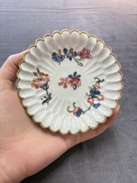 Two Chinese gilt-decorated famille rose cups and saucers with floral design, Qianlong
