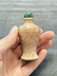 A Chinese peachbloom-crackle-glazed 'meiping' snuff bottle and a figural blue, white and copper-red snuff bottle, Yongzheng mark, 19th C.