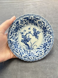 A set of six Chinese blue and white cups and saucers with floral design, Kangxi