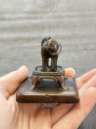 Five Chinese bronze seals and an Indonesian bronze figure group, 18/19th C.