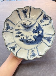 A Chinese blue and white ko-sometsuke flower-shaped tripod 'landscape' plate for the Japanese market, late Ming