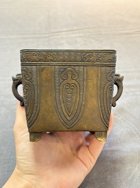 A Chinese archaistic bronze square censer with two handles, Xuande mark, Qing