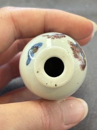 A Chinese peachbloom-crackle-glazed 'meiping' snuff bottle and a figural blue, white and copper-red snuff bottle, Yongzheng mark, 19th C.