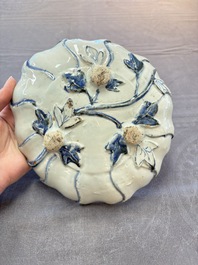 A Chinese blue and white ko-sometsuke flower-shaped tripod 'landscape' plate for the Japanese market, late Ming