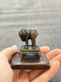Five Chinese bronze seals and an Indonesian bronze figure group, 18/19th C.