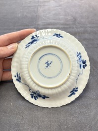 A set of six Chinese blue and white cups and saucers with floral design, Kangxi