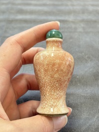 A Chinese peachbloom-crackle-glazed 'meiping' snuff bottle and a figural blue, white and copper-red snuff bottle, Yongzheng mark, 19th C.
