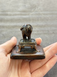 Five Chinese bronze seals and an Indonesian bronze figure group, 18/19th C.