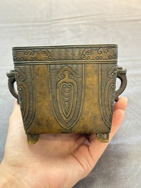 A Chinese archaistic bronze square censer with two handles, Xuande mark, Qing