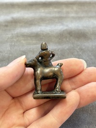 Five Chinese bronze seals and an Indonesian bronze figure group, 18/19th C.