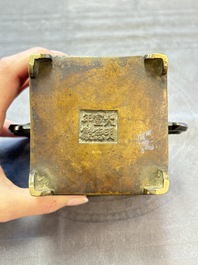 A Chinese archaistic bronze square censer with two handles, Xuande mark, Qing