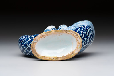 A blue, white and yellow Dutch Delft ewer in the shape of a putto on a dolphin, 18th C.