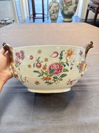 A Chinese famille rose 'mascarons' tureen and cover on stand with floral design, Qianlong