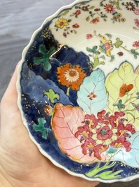 A pair of Chinese famille rose 'tobacco leaf' plates and a saucer, Qianlong