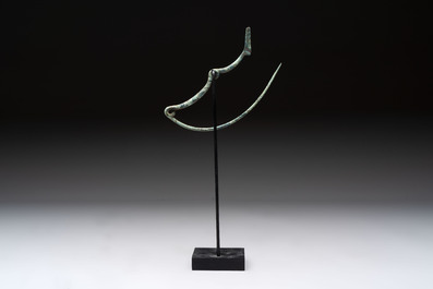 A large bronze Etruscan bow-shaped fibula and a Hungarian fibula with spring clasp, 12/7th C. B.C.
