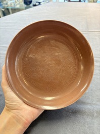 A Chinese copper-red-glazed incised 'dragon' plate, Guangxu mark and possibly of the period