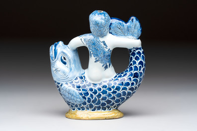 A blue, white and yellow Dutch Delft ewer in the shape of a putto on a dolphin, 18th C.