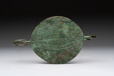 A large bronze Etruscan bow-shaped fibula and a Hungarian fibula with spring clasp, 12/7th C. B.C.