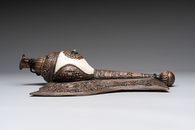 Two Tibetan brass and silver-mounted conch shell trumpets or 'Dung dkar', 19th C.