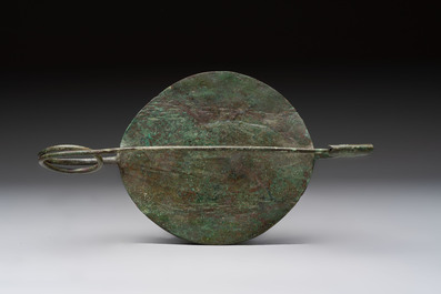 A large bronze Etruscan bow-shaped fibula and a Hungarian fibula with spring clasp, 12/7th C. B.C.