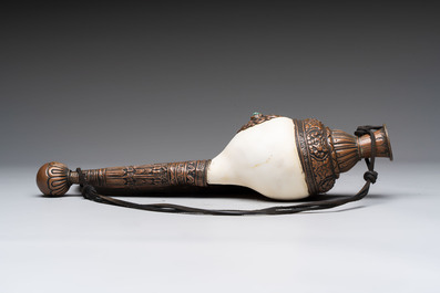 Two Tibetan brass and silver-mounted conch shell trumpets or 'Dung dkar', 19th C.