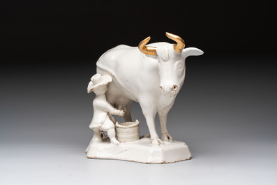 A white Dutch Delft cow milker group and a polychrome Dutch Delft parrot, 18/19th C.