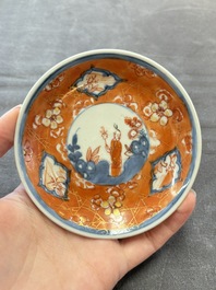 Eight Chinese blue, white and iron-red cups and twelve saucers, Kangxi/Yongzheng