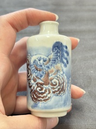Two Chinese blue, white and copper-red snuff bottles and two blue and white snuff bottles, 19th C.