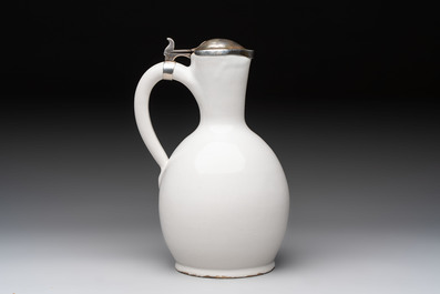 A fine white-glazed Delftware jug with silver cover, 17th C.