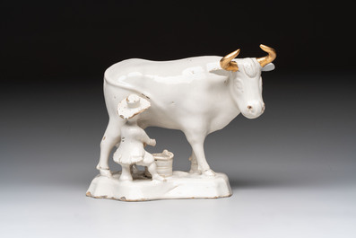 A white Dutch Delft cow milker group and a polychrome Dutch Delft parrot, 18/19th C.