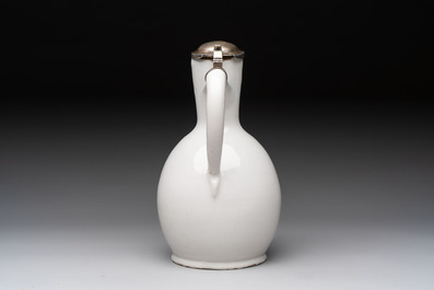 A fine white-glazed Delftware jug with silver cover, 17th C.