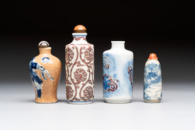 Two Chinese blue, white and copper-red snuff bottles and two blue and white snuff bottles, 19th C.