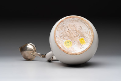 A fine white-glazed Delftware jug with silver cover, 17th C.