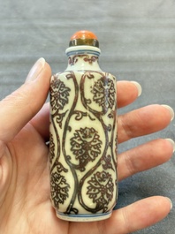 Two Chinese blue, white and copper-red snuff bottles and two blue and white snuff bottles, 19th C.