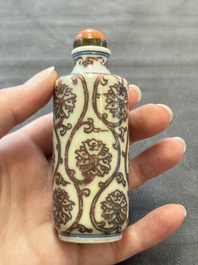 Two Chinese blue, white and copper-red snuff bottles and two blue and white snuff bottles, 19th C.