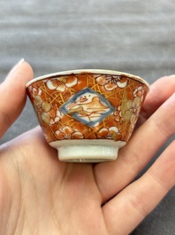 Eight Chinese blue, white and iron-red cups and twelve saucers, Kangxi/Yongzheng
