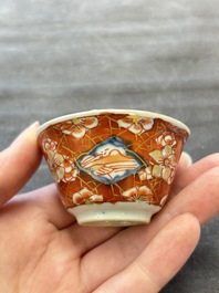 Eight Chinese blue, white and iron-red cups and twelve saucers, Kangxi/Yongzheng