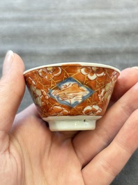 Eight Chinese blue, white and iron-red cups and twelve saucers, Kangxi/Yongzheng