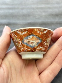 Eight Chinese blue, white and iron-red cups and twelve saucers, Kangxi/Yongzheng