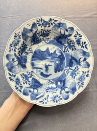 Six Chinese blue and white plates and a dish with landscape design, 18th C.