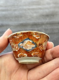 Eight Chinese blue, white and iron-red cups and twelve saucers, Kangxi/Yongzheng