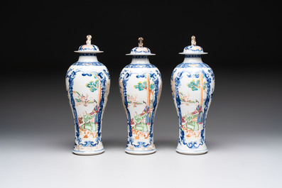 Three Chinese famille rose 'mandarin subject' vases and covers, Qianlong